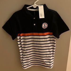 Never worn two button polo. Soft knit material. Navy, white with coral stripe.